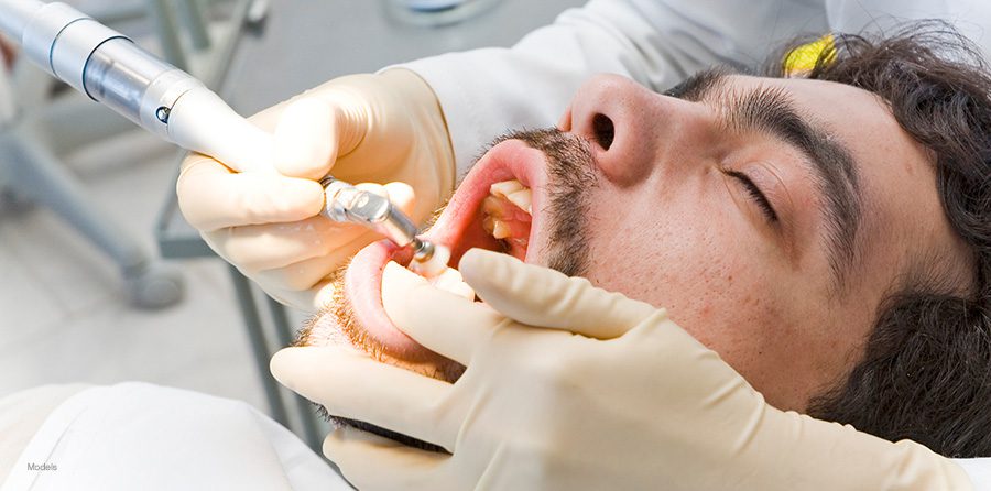 A man gets his teeth cleaned.